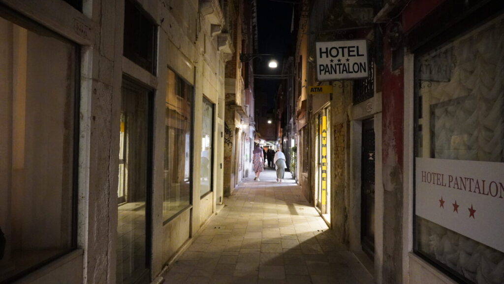 夜の細い路地に浮かび上がる「HOTEL PANTALON」の看板